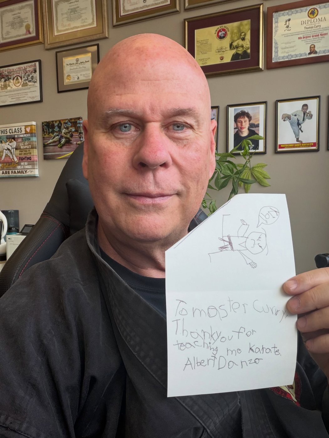 Master Curry holding a handwritten thank-you note from his student Albert at Master Curry Karate Jujutsu Ryu