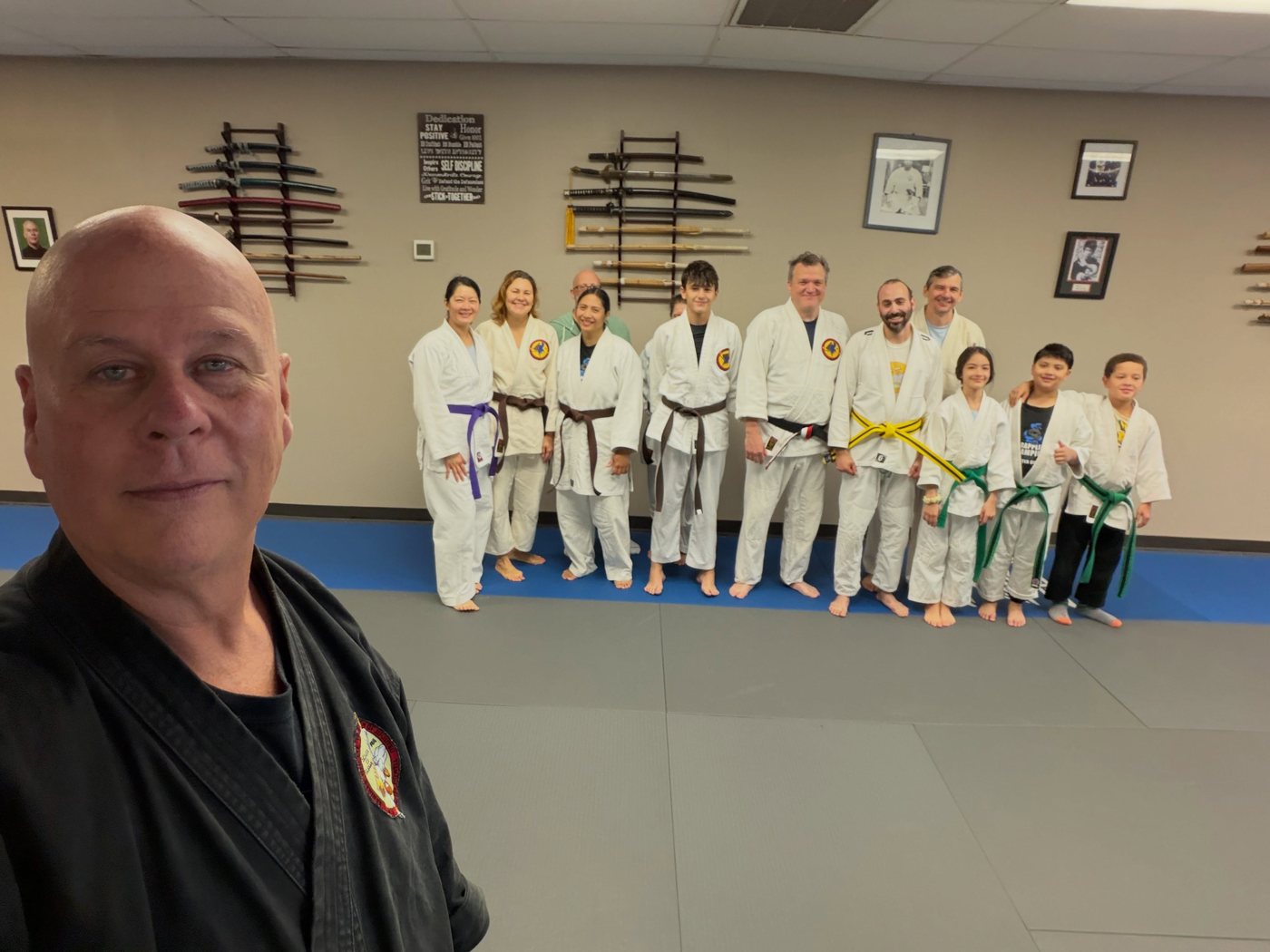 Master Tom Curry taking a selfie with his newly promoted students on the mat at Master Curry Karate Jujutsu Ryu in Staten Island